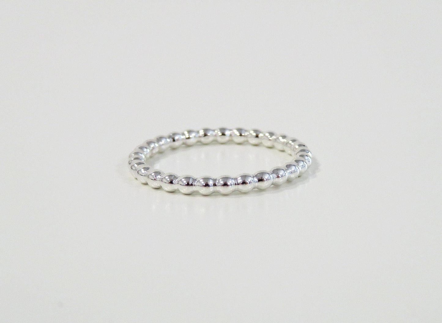 Silver ring on a light gray background