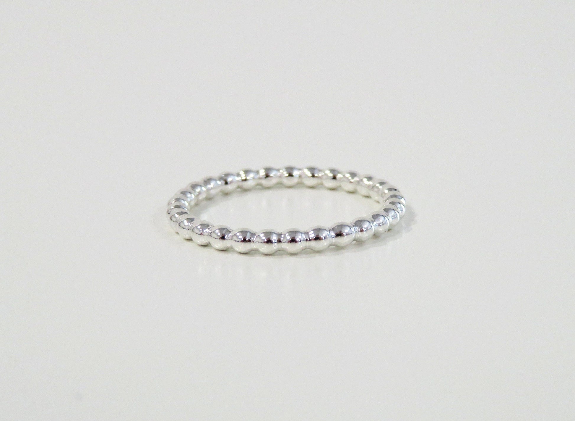 Silver ring on a light gray background