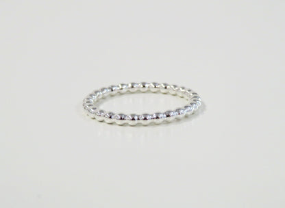 Silver ring on a light gray background