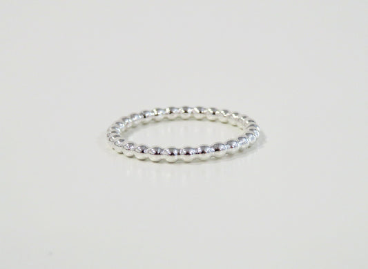 Silver ring on a light gray background
