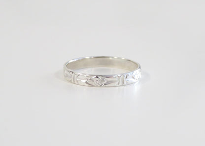 Silver ring on a light gray background