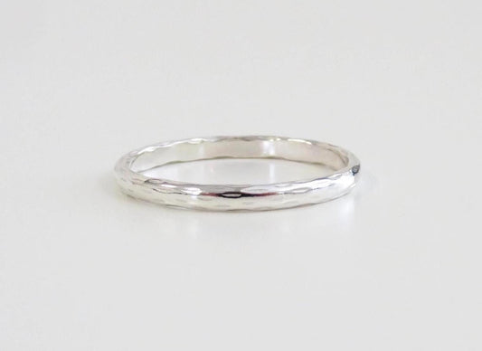 Silver ring on a light gray background