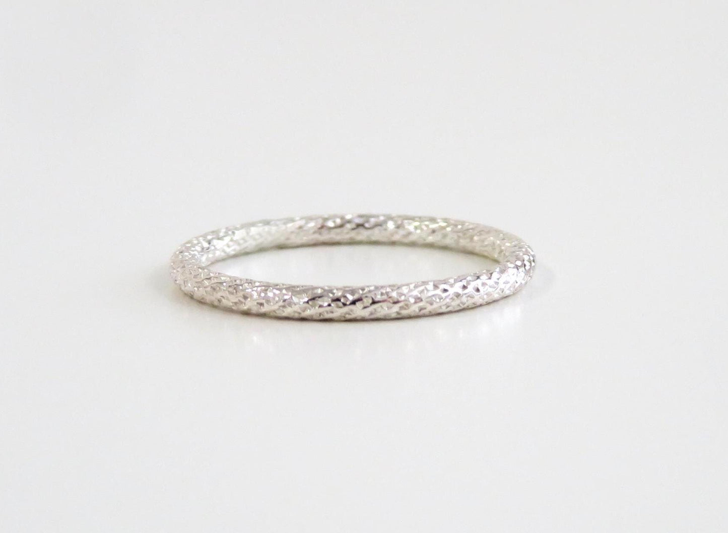 Silver ring on a light gray background