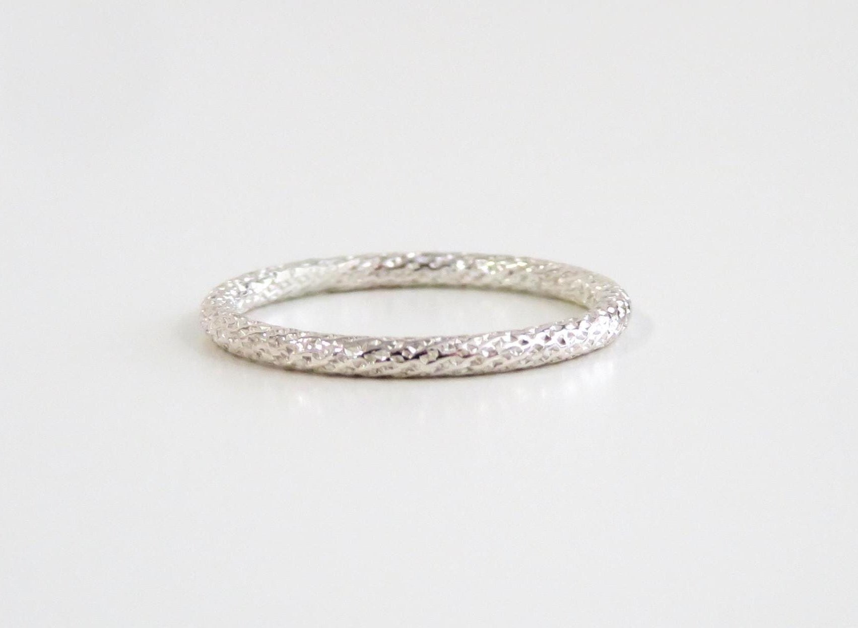 Silver ring on a light gray background