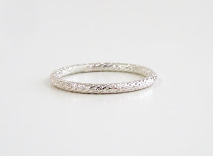 Silver ring on a light gray background